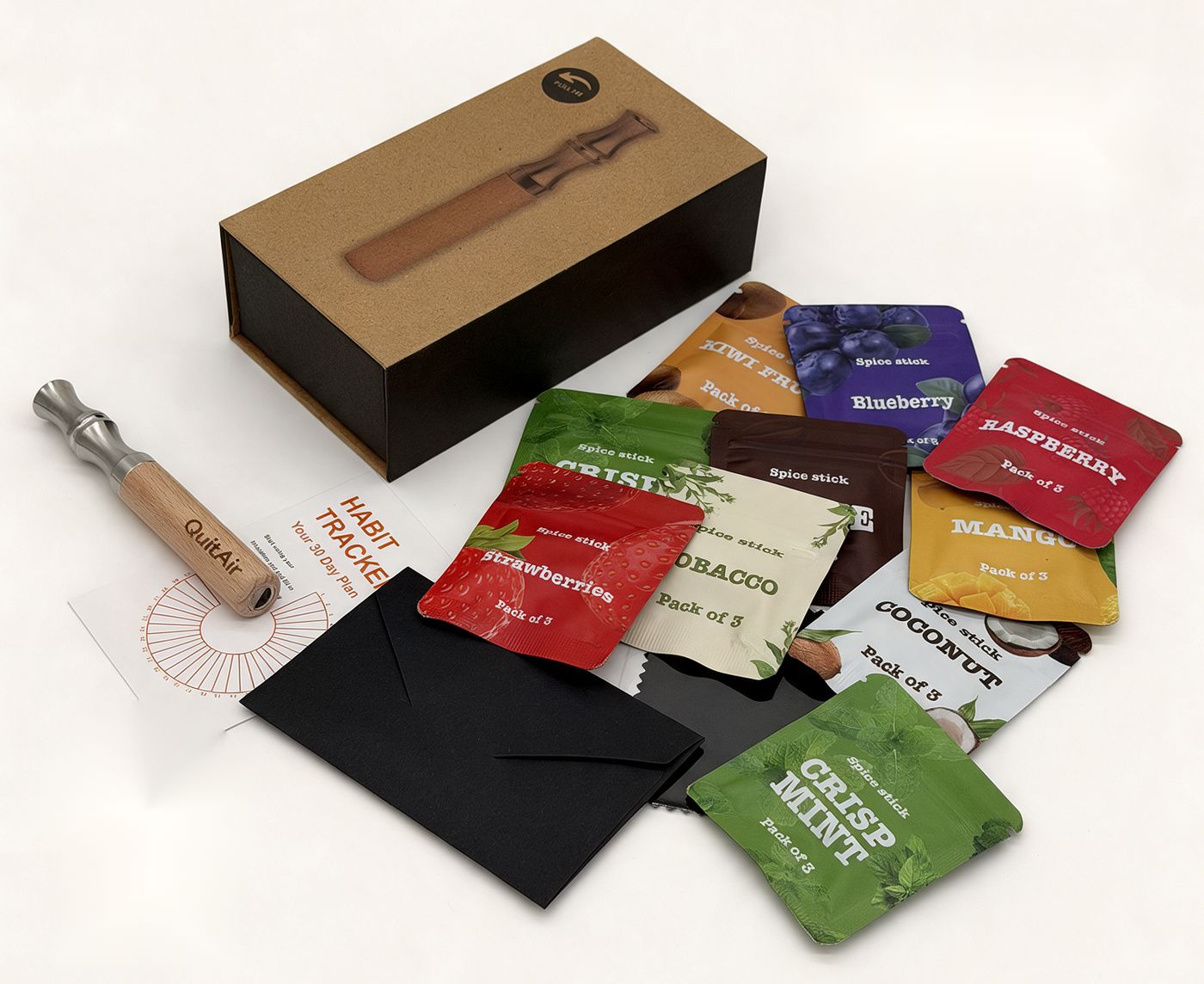 QuitAir 90-Tage Set: Geschenkbox, Holz-Mundstück, zehn bunte Aroma-Päckchen, Habit-Tracker-Karte und Reinigungstuch auf hellem Untergrund.